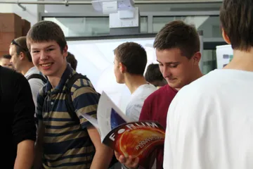Uśmiechnięci uczniowie z czasopismem „Forum Atomowe”