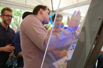 Zwiedzający dotyka podświetlanego modelu elektrowni jądrowej