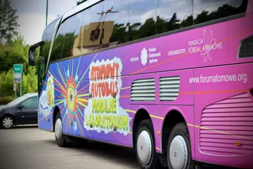 Fioletowy Atomowy Autobus z logo Fundacji na parkingu w Kopalinie